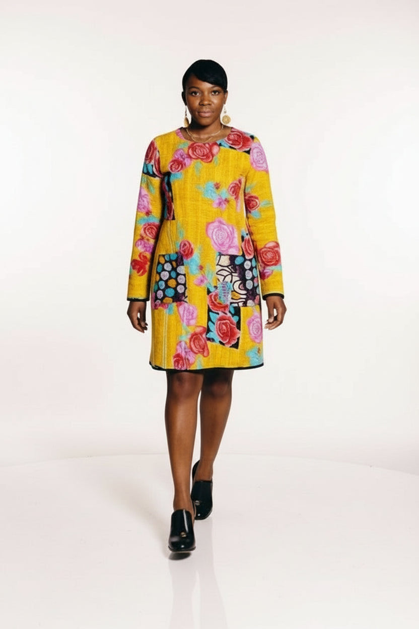 Woman wearing a colorful floral dress on a plain background