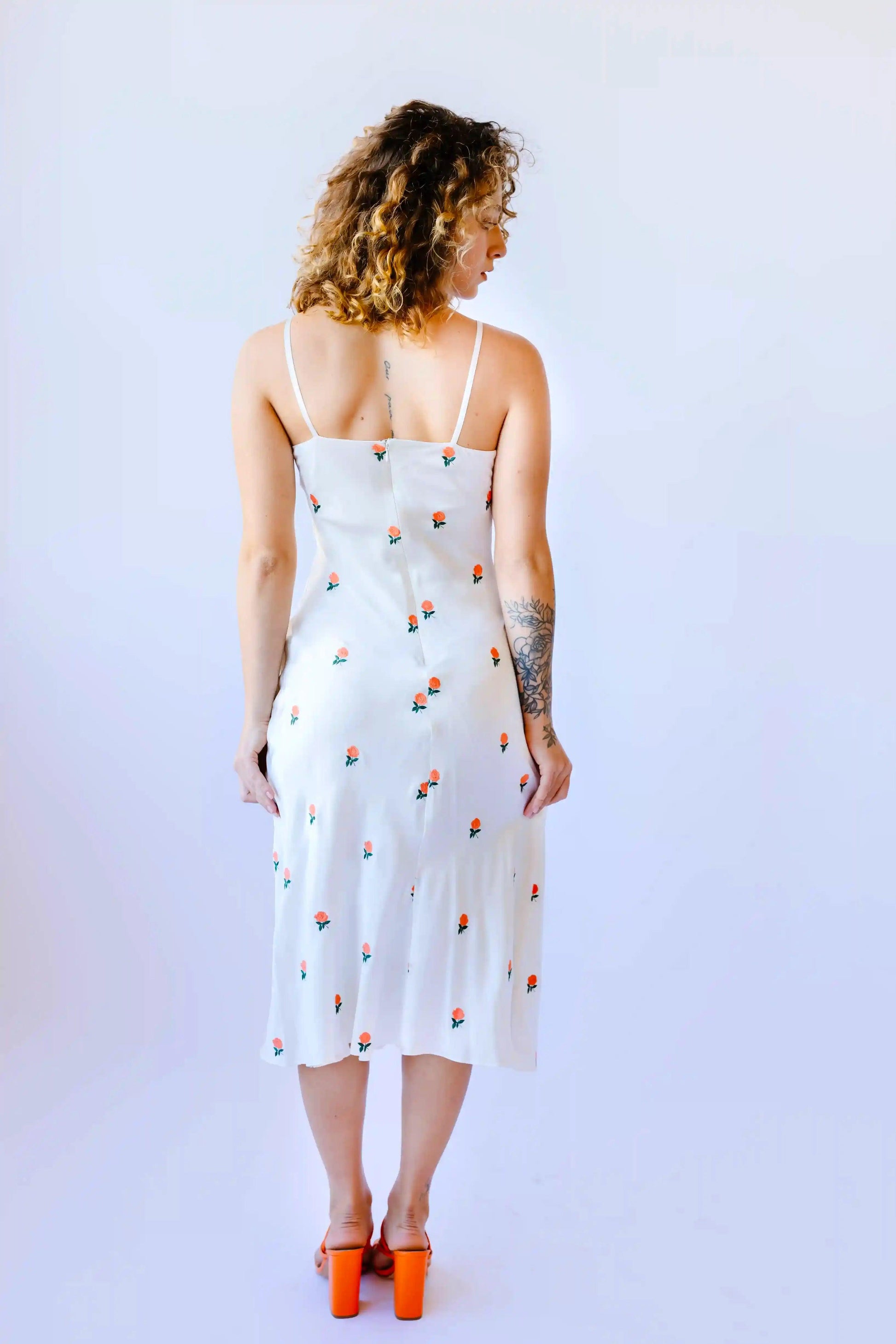 White silk slip dress with rose embroidery at Transcend